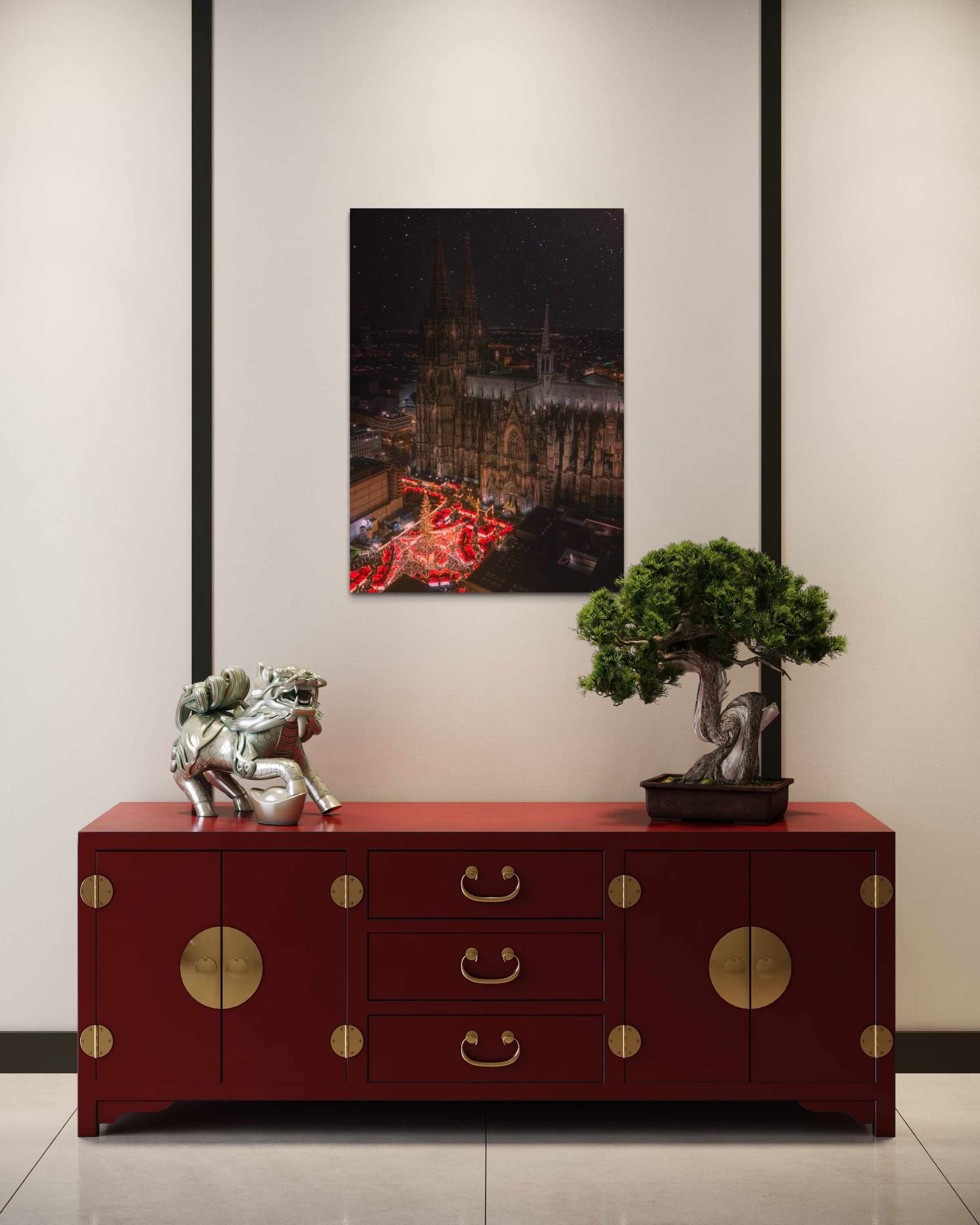 Red sideboard with gold accents in a room with a Cologne Christmas Market artwork on the wall.
