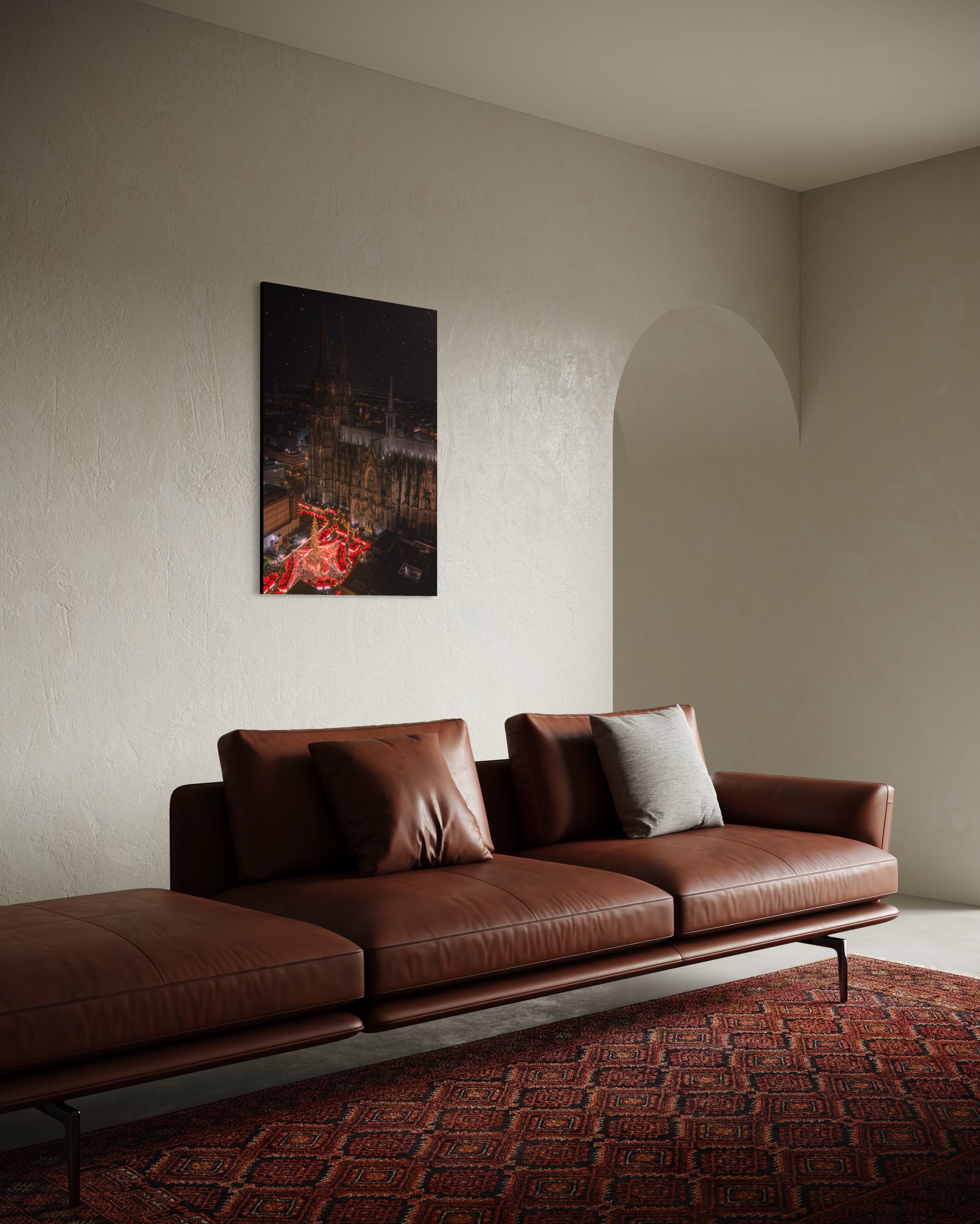 Brown leather sofa in a room with Cologne Christmas Market artwork on the wall.